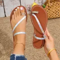 Detailed view of women's iridescent toe-ring flat sandals with sparkling rhinestone trim. - 36 / Light Blue
