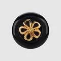 Elegant premium black circular button with a decorative golden flower-shaped metal inlay. - 11.5mm (18L) / Black+Gold