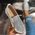 Close-up of silver glitter loafers featuring platform sole and sparkling sequins - 35 / Silver