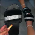 Detail view of black furry slippers featuring a sparkling rhinestone band for women - 36 / Black