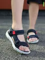 Close-up detail of children's navy blue non-slip sandals worn on an outdoor ground. - 26 / Dark Blue And Red