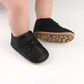 Detailed view of black faux leather baby walker shoes with secure velcro straps - 11cm / Black