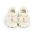 Close-up of cream baby walking shoes with waffle texture and oversized tulle bows. - 11cm / White