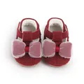 Close-up detail of maroon baby walking shoes with waffle texture and large mesh bows - 11cm / Red