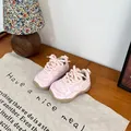 Close-up of pink distressed baby sneakers with thick rope laces on a wooden surface - Size 23 (Inner 14.5cm) / Pink