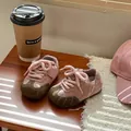 Detailed shot of pink baby sneakers with green toe caps on a wooden table - Size 29 (Inner Length 18.5cm) / Pink