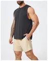 Side view of a muscular man wearing a dark gray quick-dry tank top and beige mesh athletic shorts - S / Tops / Premium Black