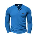 Detailed front view of blue waffle knit long sleeve Henley shirt with brown chest patch - S / Tops / Sapphire Blue