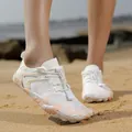 Leichte weiß-orangefarbene schnelltrocknende Mesh-Wasserschuhe an einem sandigen Strand - Weiß Rosa