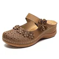 Retro brown women's wedge sandals with decorative 3D flower appliques on plain background - Brown