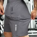 Graue, hoch elastische und schnelltrocknende Herren-Sporthose mit Reißverschlusstasche - S / Unterteile / Grau