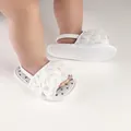 Close-up of white ruffled baby walker shoes with elastic strap and polka dot insole - 11cm (2258) / White