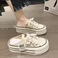 Detail shot of off-white platform canvas mules with thick laces and striped sole. - 35 / Off White