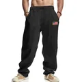 Gros plan sur un pantalon en lin noir pour homme avec écusson drapeau américain. - Noir