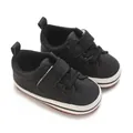 Close-up of black baby sneakers with soft soles and velcro straps for toddler boys - Black