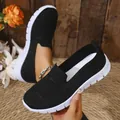 Detail view of black mesh fabric on breathable women's slip-on sneakers with white sole - 36 / Black