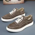 Primo piano di sneakers casual retrò da uomo in pelle scamosciata marrone con suola bianca. - Cachi (Testa di Moro)