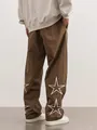 Brown high-street joggers featuring large white star embroidery on lower legs - Coffee