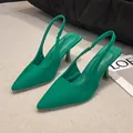Detailed view of elegant emerald green pointed-toe slingback heels with slim stiletto. - 35 / Green