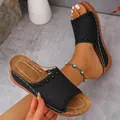 Close-up of black laser-cut wedge sandal with brown stitched footbed detail - 36 / Black