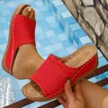 Detailed view of red retro wedge sandals with hollow-out design and white stitching. - 36 / Red
