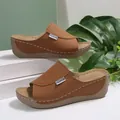 Detailed side view of brown platform wedge sandals with white stitching and peep-toe design - 36 / Tan