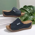 Close-up detail of navy blue wedge slippers featuring a peep-toe design and contrast stitching - Navy Blue