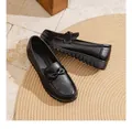 Detail view of black perforated leather loafers with bow knot and comfortable soft sole - 35 / Black