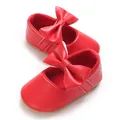 Detailed close-up of red baby girl pre-walker shoes with a large bow and soft sole - Insole Length 11cm / Red