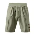 Close-up of olive green drawstring shorts featuring unique decorative side buttons - Green