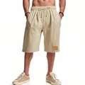 Inquadratura completa di pantaloncini larghi in lino beige da uomo con coulisse in vita - Taglia S / Pantaloni e gonne / Khaki chiaro
