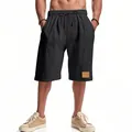 Dettaglio dei pantaloncini casual da uomo in lino nero, vestibilità ampia per l'estate - Taglia S / Pantaloni e gonne / Nero