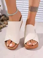 Close-up of minimalist cream wedge platform slides for summer featuring a cross-over design. - 36 / Off White