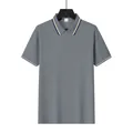Macro detail of a grey mesh polo shirt showing the lapel and three-button placket - S / Tops / Gray