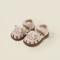 Soft pink toddler girl sandals featuring elegant bows and laser-cut floral details - Pink