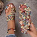Detailed view of vibrant bohemian paisley printed flat sandals with toe-loop design - Red
