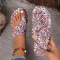 Detailed view of colorful paisley print on bohemian flat toe-loop slide sandals - Pink