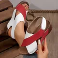 Detail view of women's red and white platform wedge sandals with cross-straps. - 36 / Red White