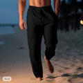 Men's black linen drawstring beach pants shown on a person walking on sand (81 chars) - Black