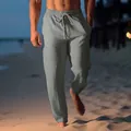 Men's grey linen beach trousers with drawstring waist shown in a seaside scene - Gray