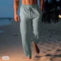 Close-up detail of green breathable linen beach pants for men with drawstring waist. - Light Green