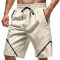 Men's beige sports shorts with black drawstring and side stripe details on a model. - Apricot