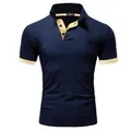 Close-up of a navy blue polo shirt featuring contrast yellow collar and cuffs detail - Navy/Orange