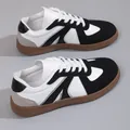 Detailed view of retro German Army Trainer sneakers in black and white leather - Black