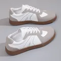 Retro German army sneakers featuring a white and grey leather design with classic brown gum soles. - Gray