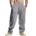 Detailed shot of men's breathable gray linen trousers with an elastic drawstring waist - Light Gray