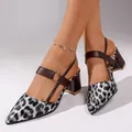 Close-up view of pointed-toe leopard print block heel pumps with brown buckle strap. - 38 / Black Leopard