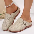 Primo piano di sabot beige da donna con motivi floreali traforati al laser e fibbia decorativa. - 36 / Bianco avorio