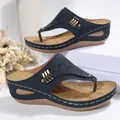 Elegant navy blue wedge thong sandals for women featuring laser-cut patterns and gold rivets - Navy Blue