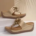 Elegant golden wedge sandals for women with large decorative flowers and thong straps - Gold